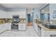 Well-equipped kitchen with white cabinets, granite countertops, and tile flooring at 340 Lazy Willow Ln, Lawrenceville, GA 30044