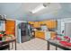 Functional kitchen with wood cabinets, black appliances, and tiled flooring at 340 Lazy Willow Ln, Lawrenceville, GA 30044