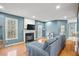Comfortable living room with a cozy fireplace, hardwood floors, and a view to the kitchen at 340 Lazy Willow Ln, Lawrenceville, GA 30044