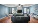 Inviting living room featuring a stylish couch, dark furnishings, hardwood floors, and plenty of natural light at 340 Lazy Willow Ln, Lawrenceville, GA 30044