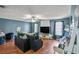 Spacious living room with stylish furnishings, hardwood floors, an expansive window, and a ceiling fan at 340 Lazy Willow Ln, Lawrenceville, GA 30044