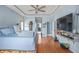 Spacious main bedroom features hardwood floors, a ceiling fan, a tv, and an expansive, bright window at 340 Lazy Willow Ln, Lawrenceville, GA 30044