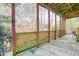 A covered patio with latticework railing offers a serene outdoor space at 340 Lazy Willow Ln, Lawrenceville, GA 30044