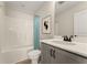 Well-lit bathroom featuring a tub with shower, stylish blue shower curtain, and gray vanity with a white countertop at 48 Masters Dr, Villa Rica, GA 30180