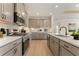 Modern kitchen with stainless steel appliances, sleek countertops, ample cabinet space and hardwood flooring at 48 Masters Dr, Villa Rica, GA 30180