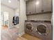 Well-equipped laundry room with modern washer, dryer, and storage cabinets at 48 Masters Dr, Villa Rica, GA 30180