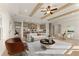 Bright living room with coffered ceilings, fireplace, and open floor plan to kitchen and dining area at 48 Masters Dr, Villa Rica, GA 30180