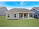 Large backyard featuring a covered patio, outdoor seating, and plenty of green grass at 61 Colonial Terrace, Villa Rica, GA 30180