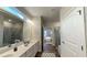 Elegant bathroom featuring double vanity sinks, and a glass-enclosed shower at 61 Colonial Terrace, Villa Rica, GA 30180