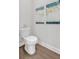 Bright bathroom with a modern toilet, artwork on the wall and wood-style flooring at 61 Colonial Terrace, Villa Rica, GA 30180