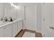 Bright bathroom with dual sinks, white cabinets, and ample counter space at 61 Colonial Terrace, Villa Rica, GA 30180