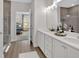 Luxury bathroom featuring dual sinks, a tiled shower, and stylish finishes at 61 Colonial Terrace, Villa Rica, GA 30180