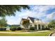 Beautiful home exterior with a columned porch, manicured lawn and mature landscaping at 61 Colonial Terrace, Villa Rica, GA 30180