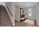 Inviting foyer with hardwood floors, staircase, stylish mirror, and a convenient bench at 61 Colonial Terrace, Villa Rica, GA 30180