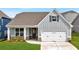 Charming craftsman-style home with gray siding, white trim, and an attached two-car garage at 61 Colonial Terrace, Villa Rica, GA 30180
