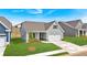 Desirable home with gray siding, an attached two-car garage, and a wonderfully manicured lawn at 61 Colonial Terrace, Villa Rica, GA 30180