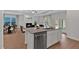 Island in bright kitchen with stainless dishwasher, sink, and granite countertops at 61 Colonial Terrace, Villa Rica, GA 30180