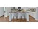 Bright kitchen island with bar stools, granite countertops, and modern appliances at 61 Colonial Terrace, Villa Rica, GA 30180