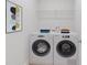 Bright laundry room featuring modern front loading washer and dryer units at 61 Colonial Terrace, Villa Rica, GA 30180