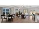 Bright living room with fireplace, dining table, modern furniture, and lots of natural light at 61 Colonial Terrace, Villa Rica, GA 30180