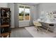 Bright home office with a large window, neutral decor, and modern desk setup at 61 Colonial Terrace, Villa Rica, GA 30180
