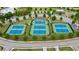 Aerial view of community tennis courts, lush landscaping, and convenient parking at 61 Colonial Terrace, Villa Rica, GA 30180