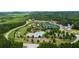 Aerial view of a community featuring pool, tennis courts, playground, and green spaces surrounded by trees at 71 Colonial Terrace, Villa Rica, GA 30180