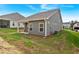 Back of a gray home with well-maintained landscaping and an outdoor patio at 71 Colonial Terrace, Villa Rica, GA 30180