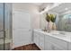 Bright bathroom with double sink vanity, contemporary lighting, and tiled shower at 71 Colonial Terrace, Villa Rica, GA 30180
