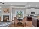 This dining room has a fireplace and eat-in kitchen with white cabinets and stainless appliances at 71 Colonial Terrace, Villa Rica, GA 30180