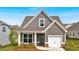 Charming single Gathering home featuring gray siding, white trim and a cozy covered front porch at 71 Colonial Terrace, Villa Rica, GA 30180