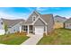 Single-Gathering home boasts a manicured lawn, a one-car garage, and pleasing gray siding at 71 Colonial Terrace, Villa Rica, GA 30180