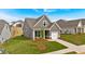 Beautifully landscaped yard compliments this cozy home with its gray vertical siding and white trim at 71 Colonial Terrace, Villa Rica, GA 30180