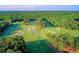 Aerial view of a picturesque golf course with sand traps and dense surrounding trees at 71 Colonial Terrace, Villa Rica, GA 30180