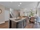 Open-concept kitchen with a center island, hardwood floors, and seamless flow to the living and dining areas at 71 Colonial Terrace, Villa Rica, GA 30180