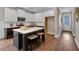 Modern kitchen featuring white cabinets, dark countertops, a center island with seating and stainless steel appliances at 71 Colonial Terrace, Villa Rica, GA 30180