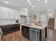 Contemporary kitchen featuring an island with a sink, stainless steel dishwasher, and hardwood floors at 71 Colonial Terrace, Villa Rica, GA 30180