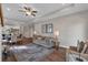 Open-concept living room showcasing hardwood floors, a ceiling fan, and seamless flow to the dining and kitchen areas at 71 Colonial Terrace, Villa Rica, GA 30180