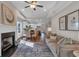 Bright living room featuring a fireplace, mantel, hardwood floors and an open floorplan leading to the kitchen at 71 Colonial Terrace, Villa Rica, GA 30180