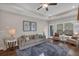 Cozy living room with hardwood floors, ceiling fan, neutral paint and a comfortable sofa with decorative pillows at 71 Colonial Terrace, Villa Rica, GA 30180
