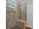 Modern tiled shower with a built-in seat and glass enclosure at 71 Colonial Terrace, Villa Rica, GA 30180