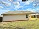 Rear exterior view showing the home's vinyl siding, covered patio, and well-maintained lawn at 125 Whistle Way, Locust Grove, GA 30248
