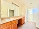 Double vanity bathroom with a large mirror and wooden cabinets and ensuite access at 125 Whistle Way, Locust Grove, GA 30248