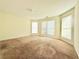 Bright bedroom showcasing neutral carpet, natural light from multiple windows, and ample space at 125 Whistle Way, Locust Grove, GA 30248