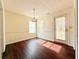 Dining room featuring hardwood floors, pendant lighting, and natural light from the windows at 125 Whistle Way, Locust Grove, GA 30248