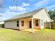 Rear exterior view showcasing the home's covered patio and fenced-in backyard at 125 Whistle Way, Locust Grove, GA 30248