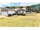 Inviting single-story home showcasing stone detailing and a spacious front yard at 125 Whistle Way, Locust Grove, GA 30248