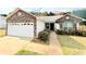 Cozy single-story home with stone accents and a convenient two-car garage at 125 Whistle Way, Locust Grove, GA 30248