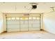 Spacious garage featuring an automatic door and ample room for vehicles and storage at 125 Whistle Way, Locust Grove, GA 30248