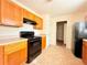 Cozy kitchen with wooden cabinetry, laminate countertops and modern, black appliances at 125 Whistle Way, Locust Grove, GA 30248